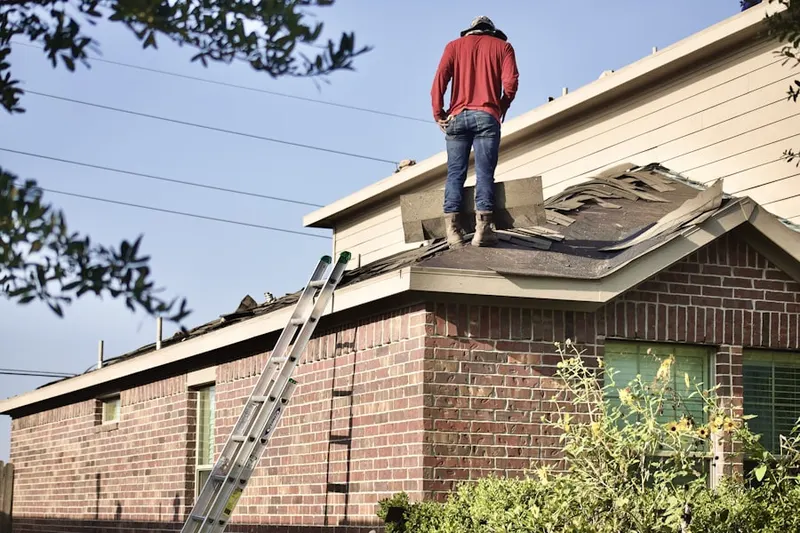Professional roofer working on a residential roof in Roanoke